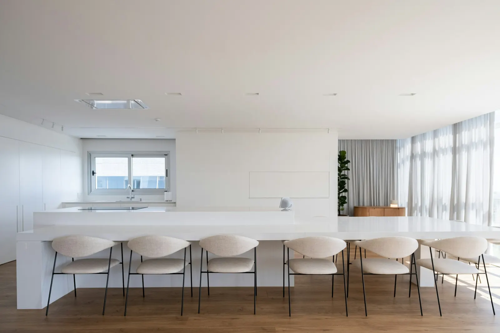 The white kitchen island with upholstered chairs