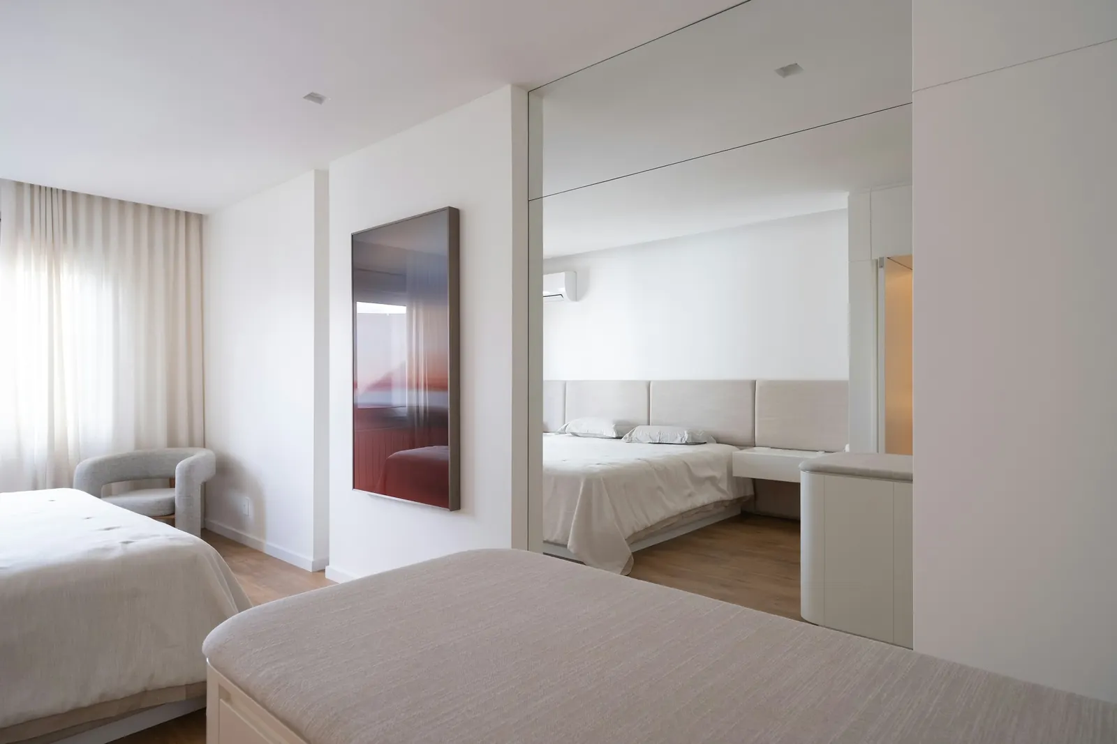 The main bedroom with an upholstered headboard