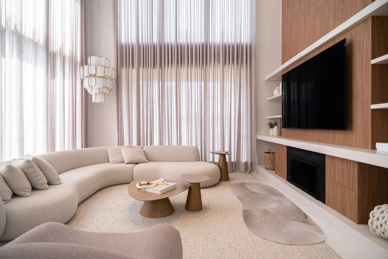 The double-height living room and the walnut wall that hides storage and the fireplace