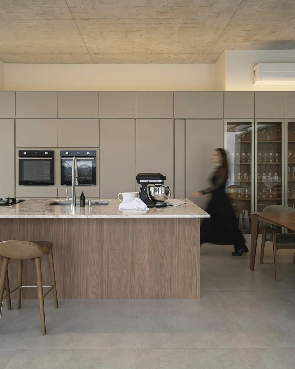 Floor-to-ceiling cabinetry with two ovens at eye level