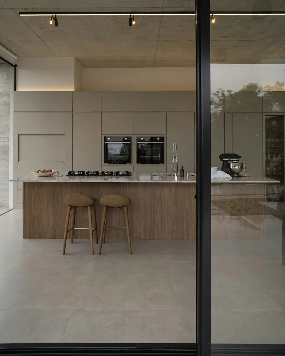 The kitchen seen from the garden through the glazing