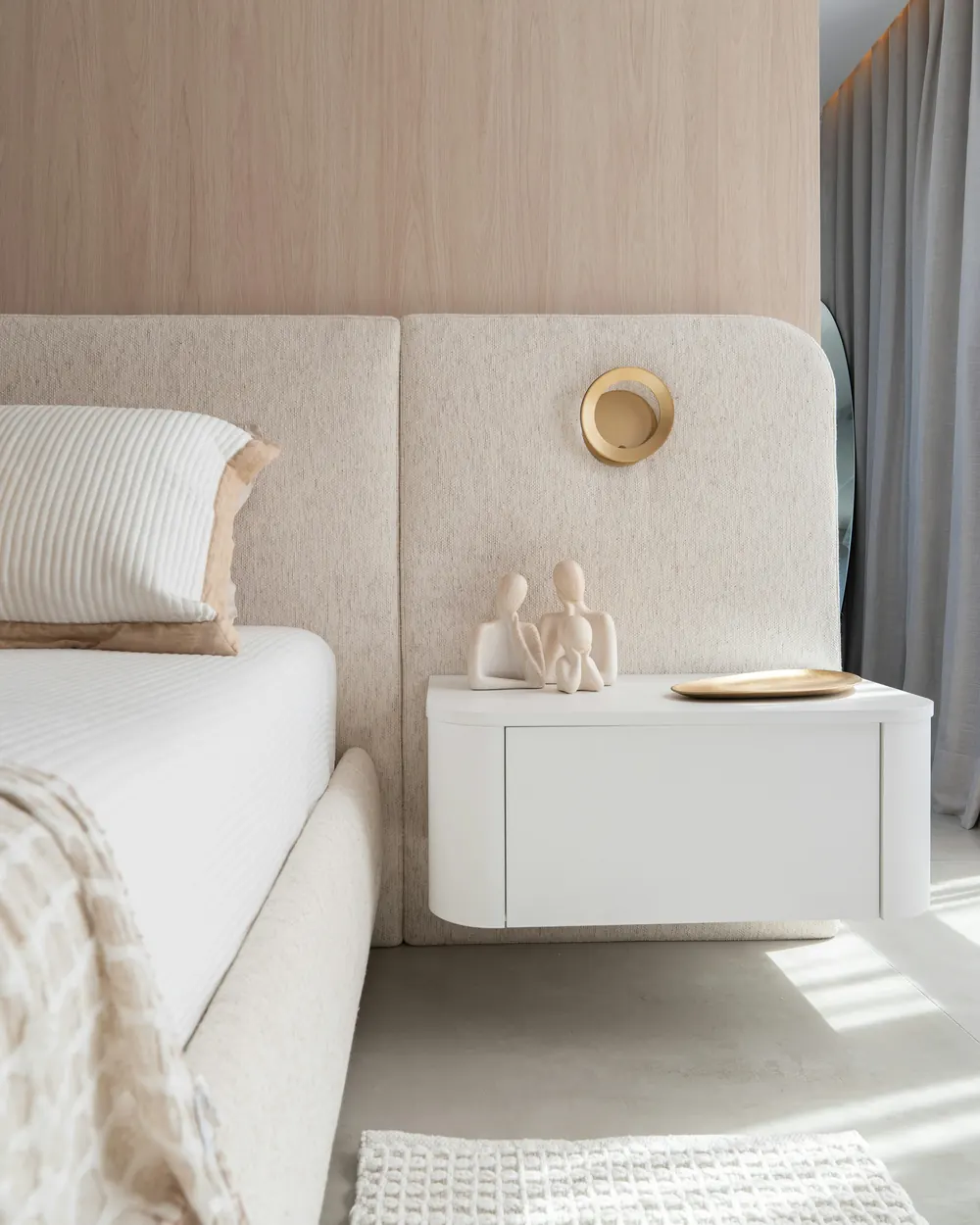 The bed, the oak wall and a floating bedside table