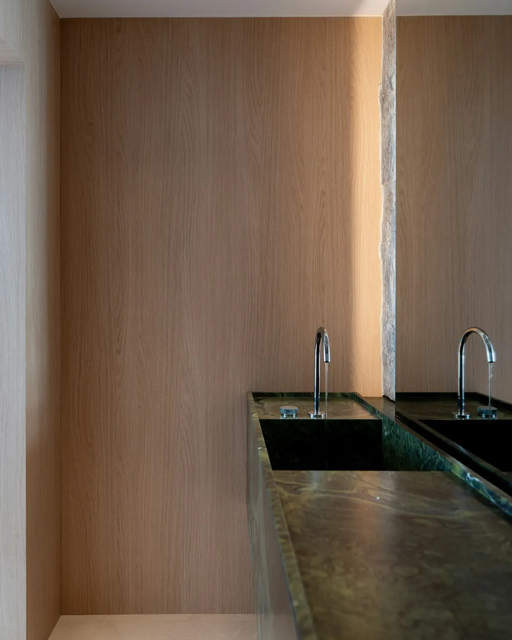 The double vanity with lighting hidden in the wall