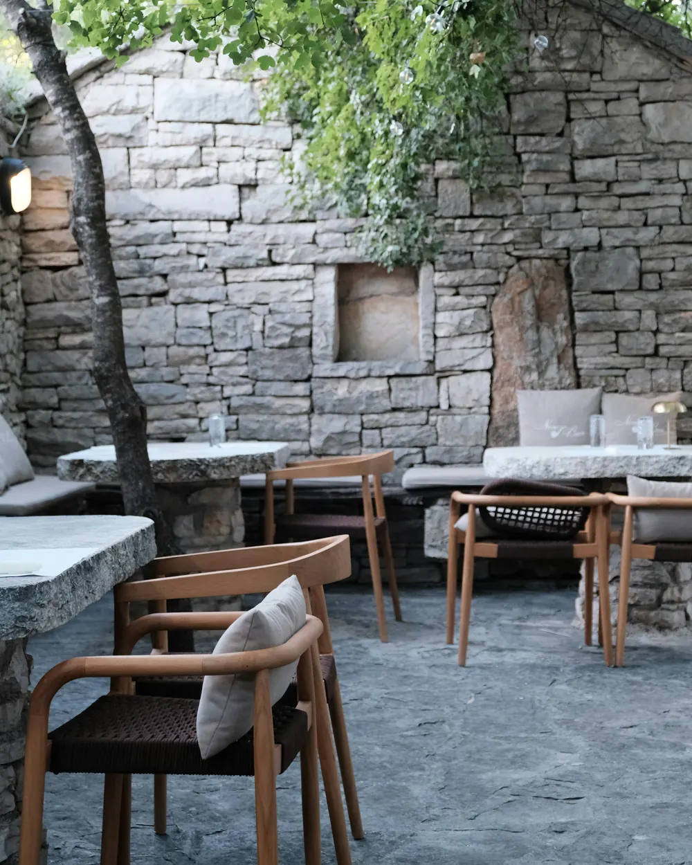 The courtyard with its original stone wall and stone tables