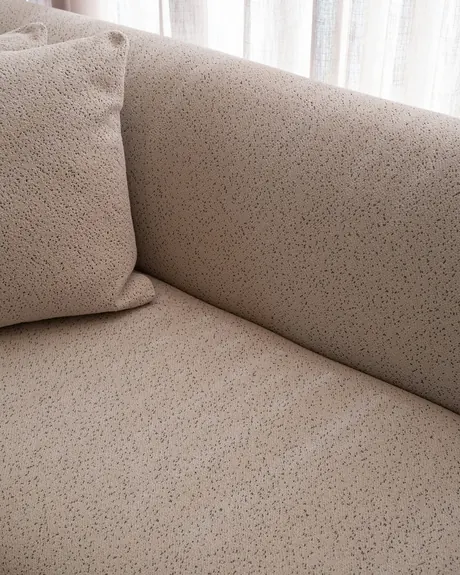 Close-up of stone-coloured bouclé on a sofa